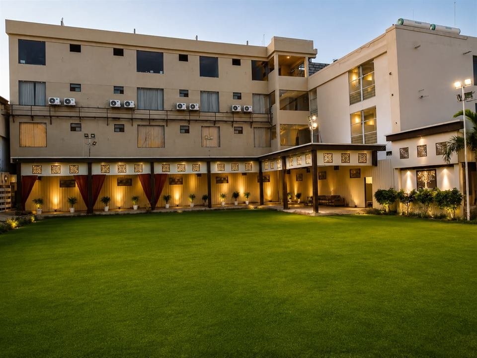 Garden lawn at dusk with lit pavilion